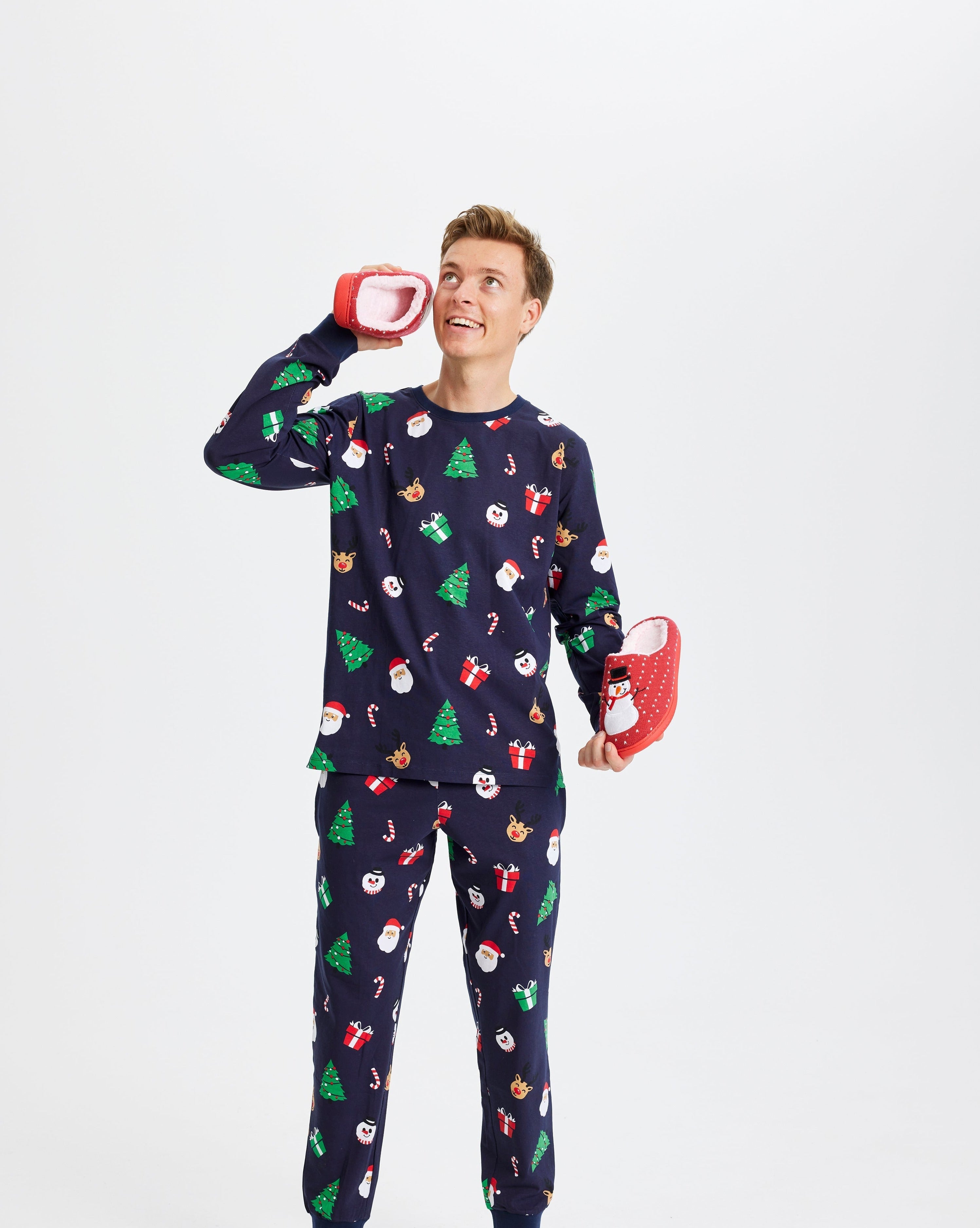 Ein Mann in einem blauen Weihnachtspyjama mit Weihnachtsbäumen.